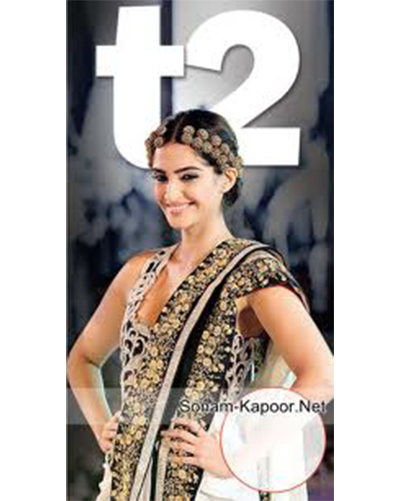 Image featuring Sonam Kapoor, posing in style with a sleeveless dress infront of the t2 poster
