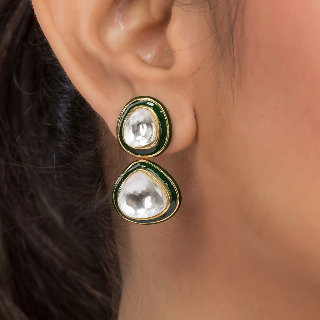 A piece of Aaravi Earrings hanging from an ear