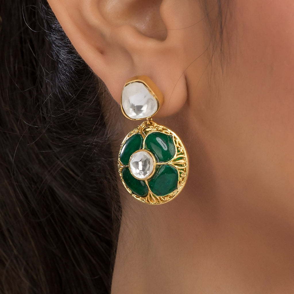 A piece of Aishani Earrings can be seen on a model's ear
