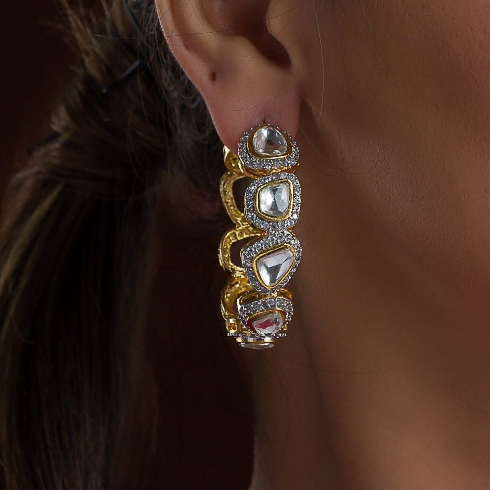 One Nermin Earrings is presented on a model's ear