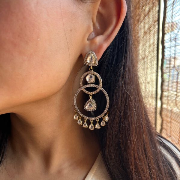 A woman is wearing beautiful Erina Earrings on her left ears