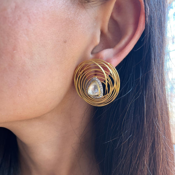 The picture showcases a model wearing Rida Earrings on left ear 