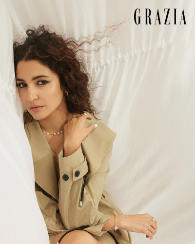 Anushka Sharma is posing with simple, beaded necklace