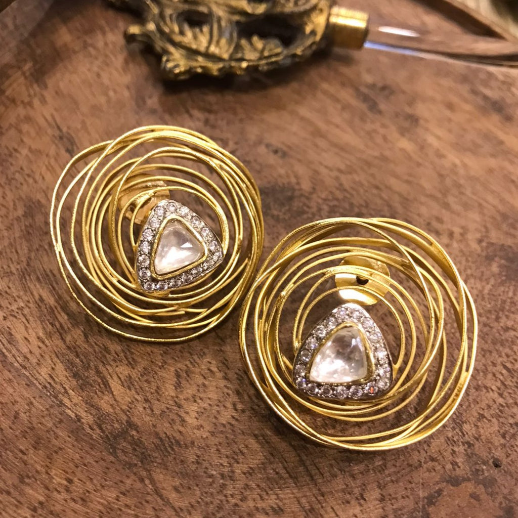 The image presents Rida Earrings with a brilliant gemstone from Vasundhara Jewelry