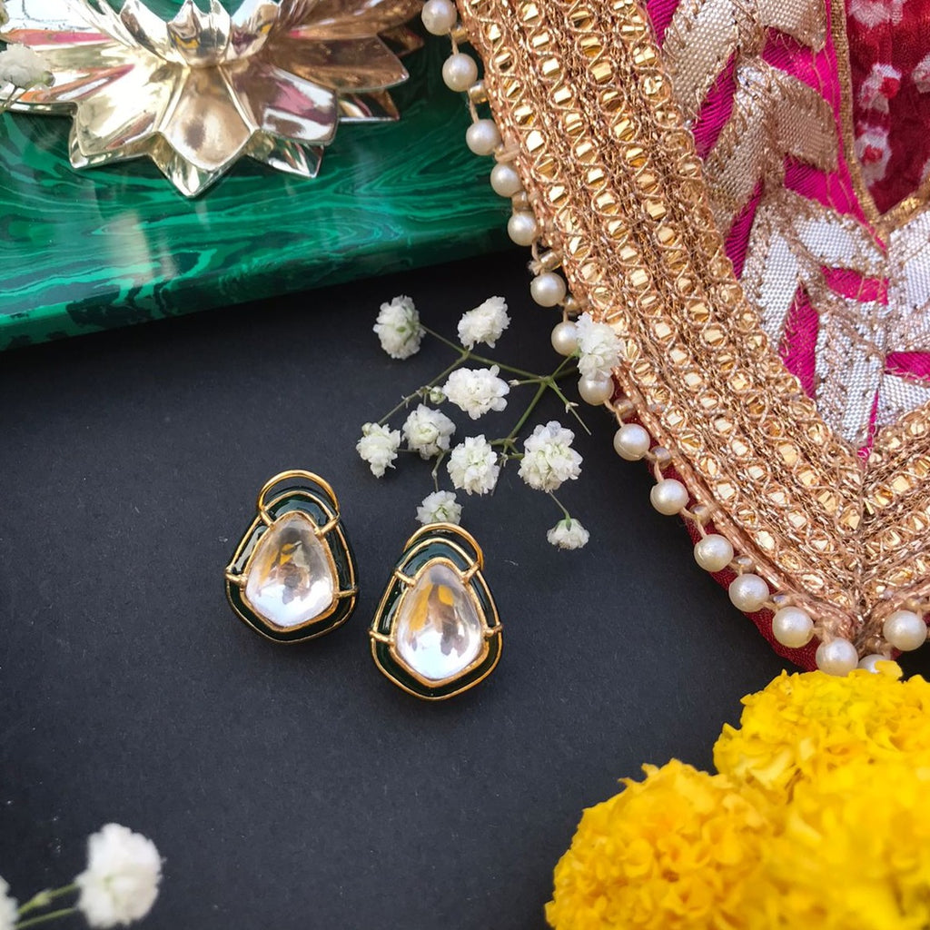 Greenstone Earrings from Vasundhara is displayed with a background of flowers