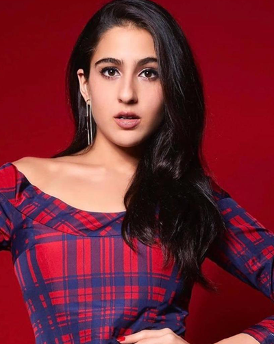 Sara Ali Khan posing in western outfit with stylish earrings 