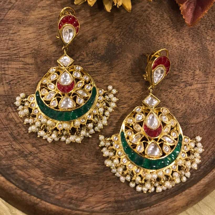 Mariam Kundan Chandbaali placed on a wooden matter